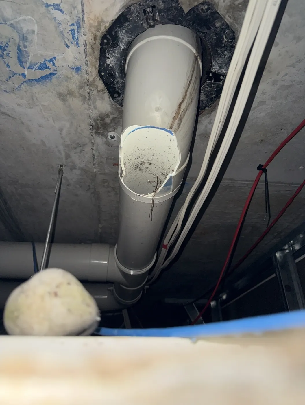 Broken PVC drainage pipe under a building