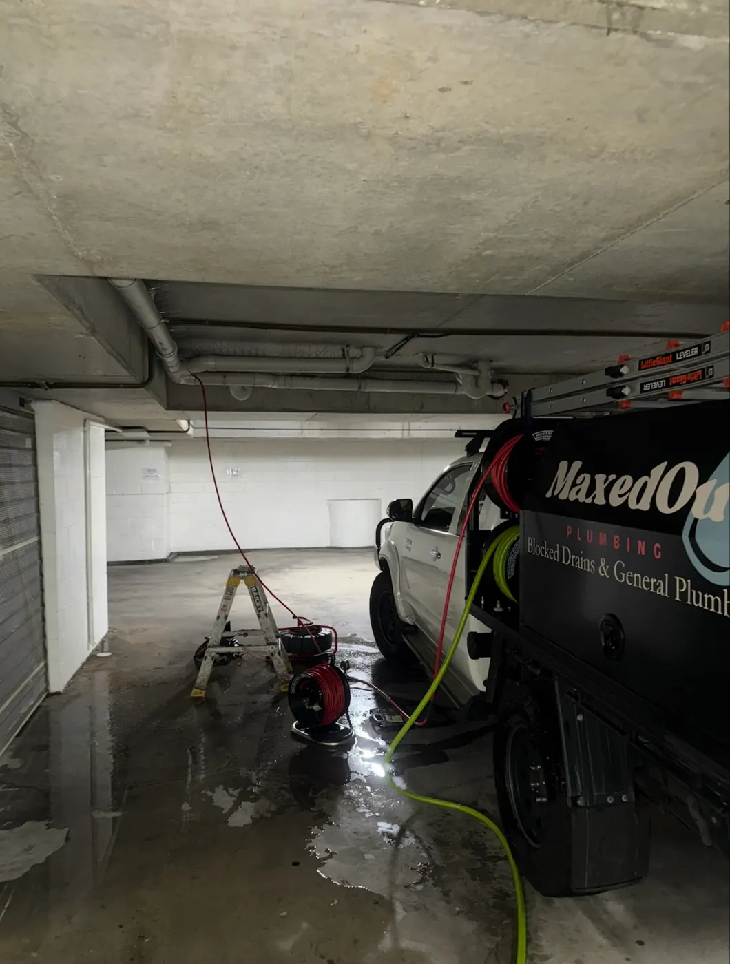 Jet blaster hose running from the MaxedOut ute in an apartment building car park