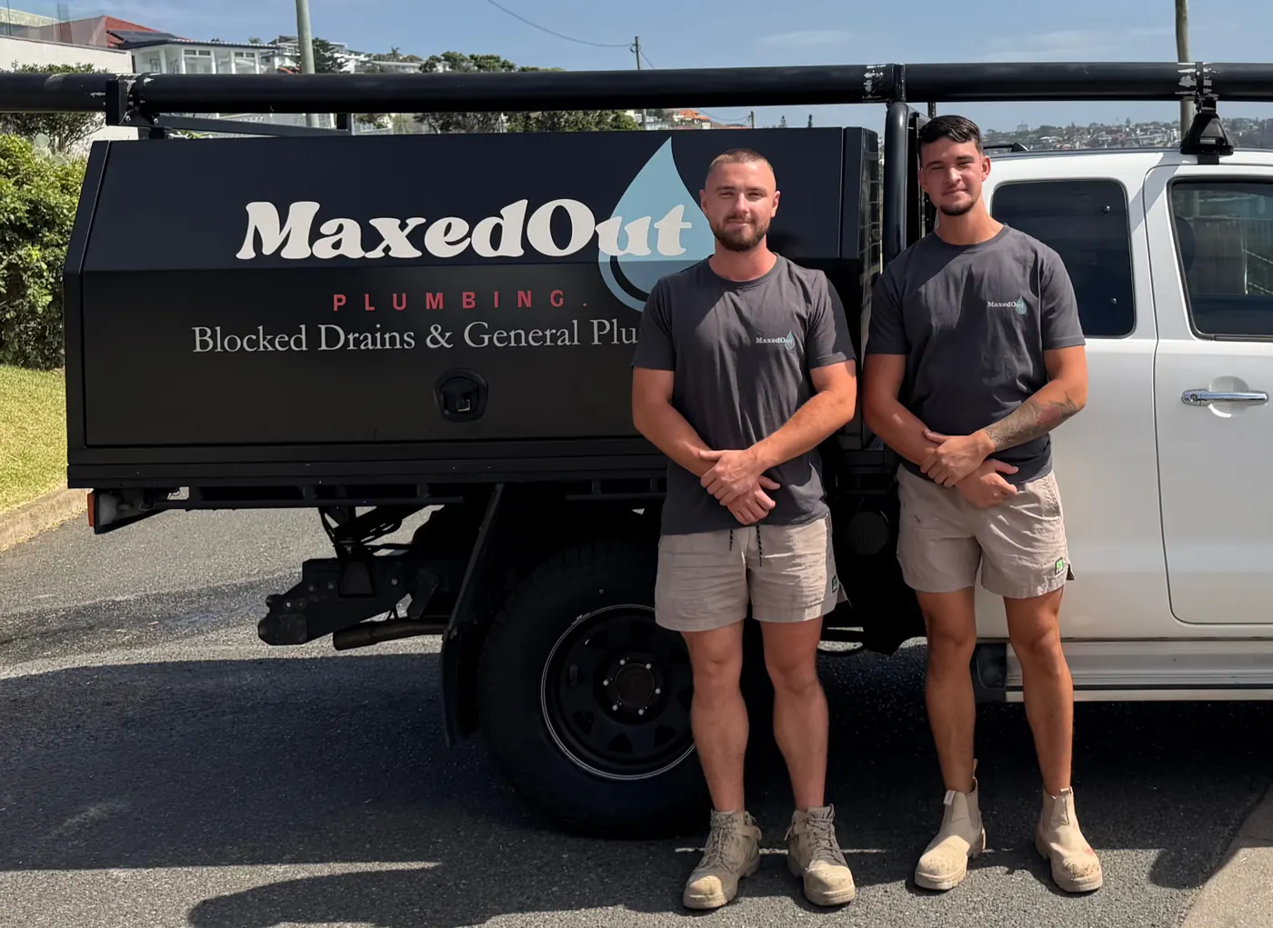 Max, on the left, and a MaxedOut plumber standing beside the signwritten ute